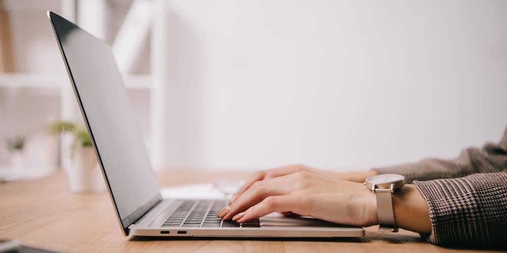 A person typing on a laptop